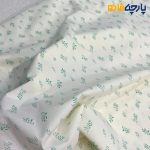 پارچه بهاره و تابستانه کتان نخ طرحدار زمینه رنگ لیمویی طرح برگ رنگ سبز آبی