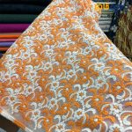 پارچه مجلسی تور کتان زمینه تور ظریف طرح برجسته رنگ نارنجی کرم عرض ۱۴۵