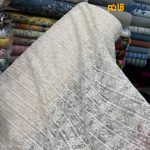 پارچه مجلسی تور کتان طرح برجسته خطی و با زمینه طرح دایره رنگ شیری