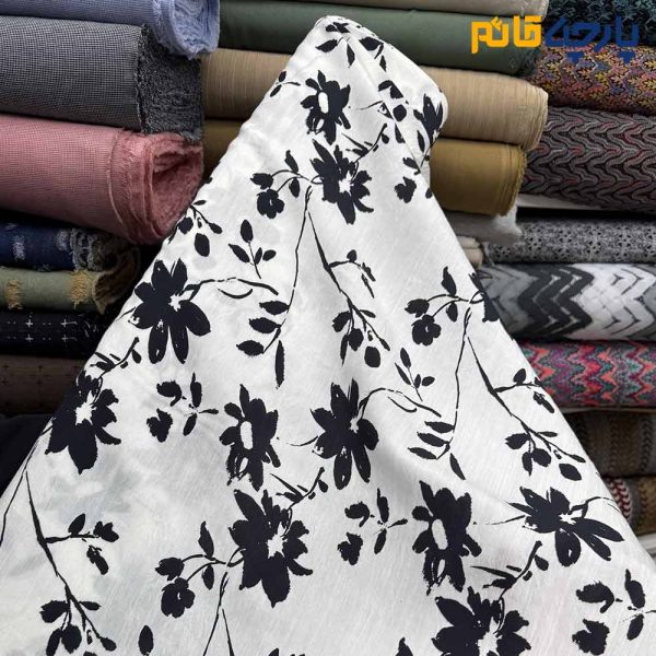 پارچه بهاره تابستانه لینن طرحدار ایتالیایی زمينه سفيد گل مشكي
