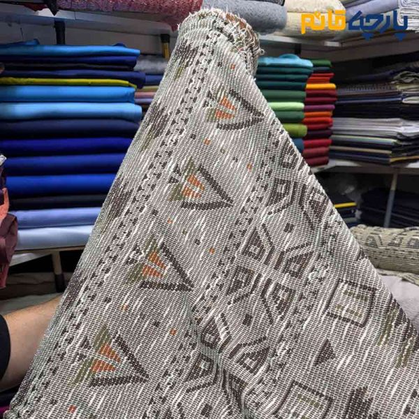 پارچه پاییزه و زمستانه بافت تریکو طرح موناکو رنگ کرم طلایی با نارنجی